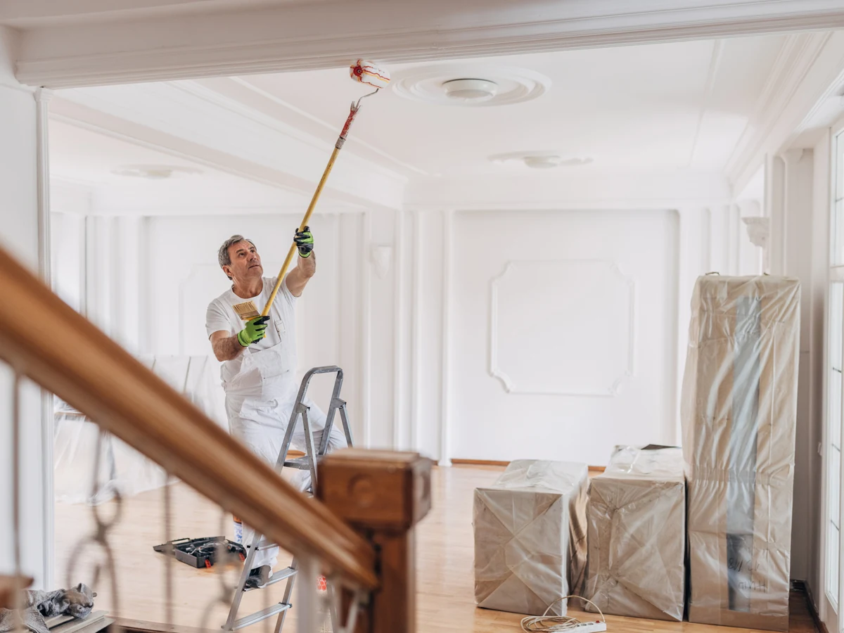 Painter working on a white ceiling in Barnstaple
