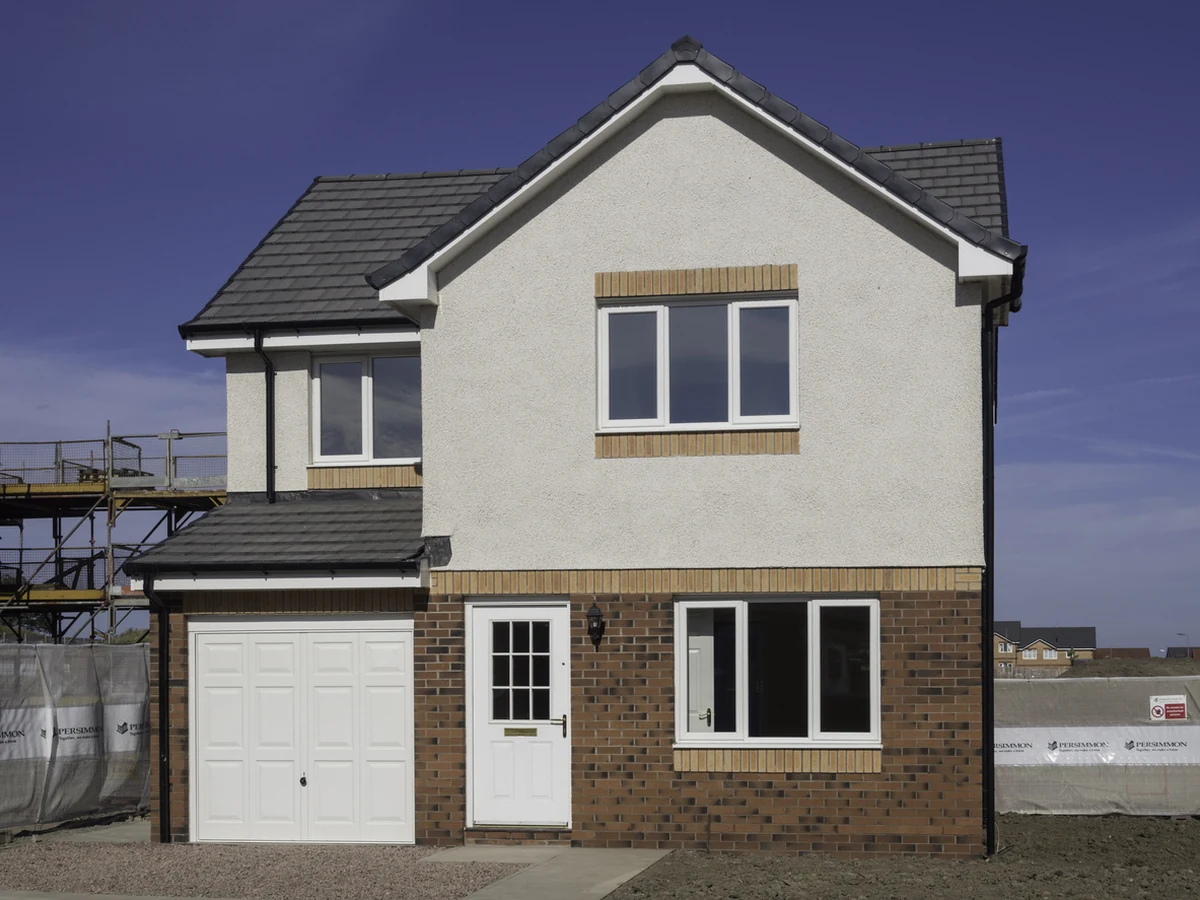 exterior-painting-new-build-detached-barnstaple-decorators New-build detached house with a cream rendered upper storey, brick base and a garage