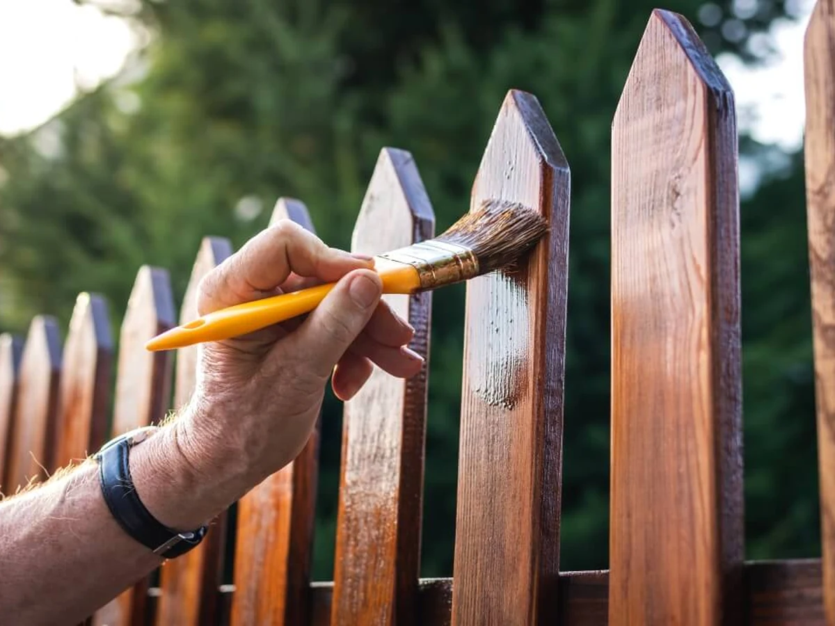 Hand painting wooden picket fence in Barnstaple by Barnstaple Decorators