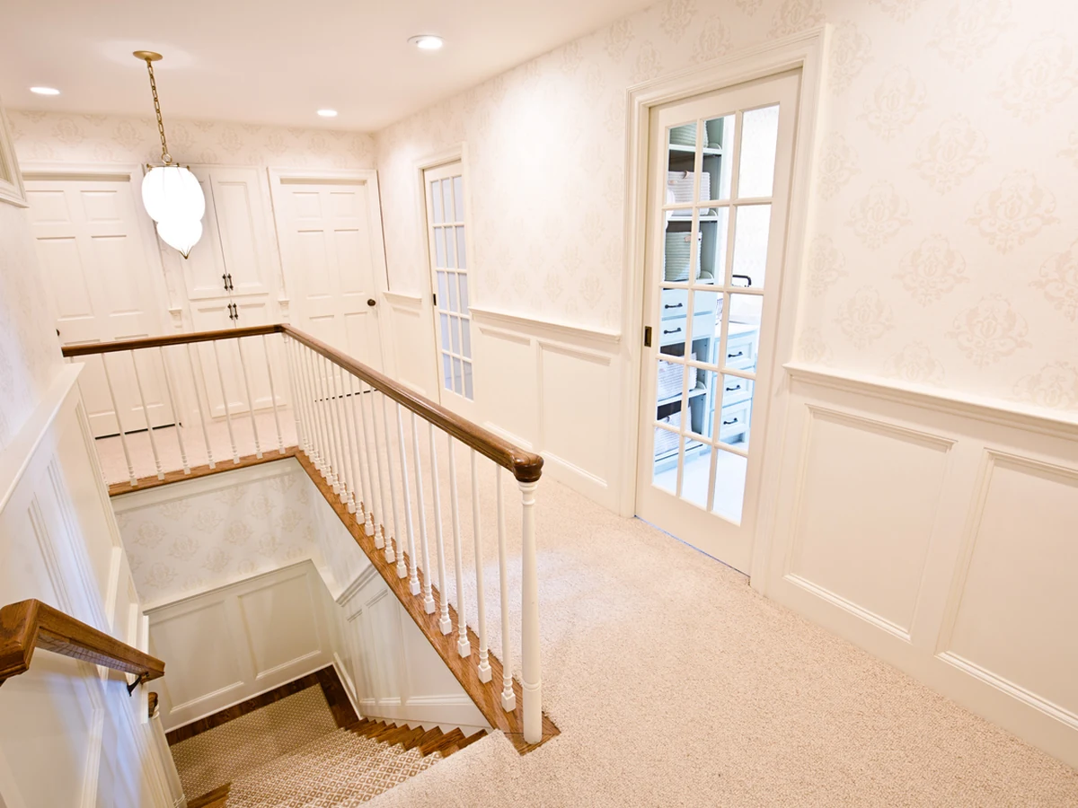 Bright upstairs landing with freshly painted staircase by Barnstaple Decorators