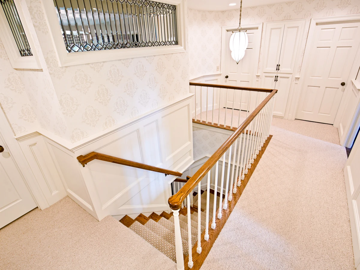 Elegant white banister staircase painted by Barnstaple Decorators
