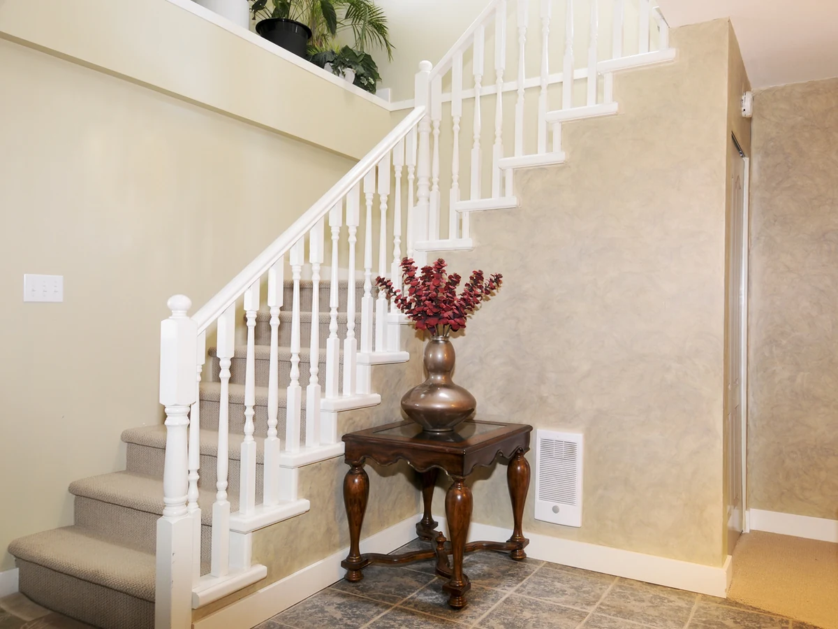 Hallway with white staircase painted by Barnstaple Decorators