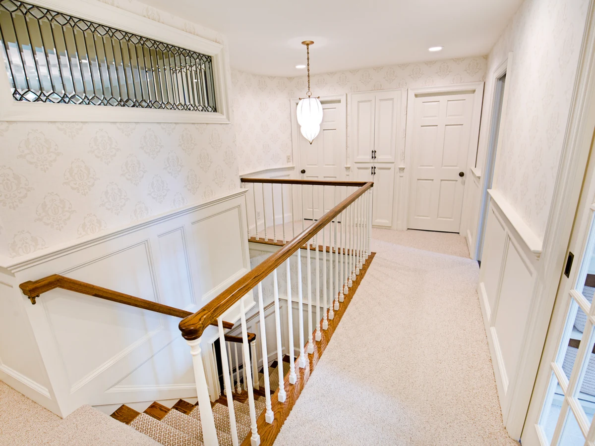 Residential stairwell painted white by Barnstaple Decorators