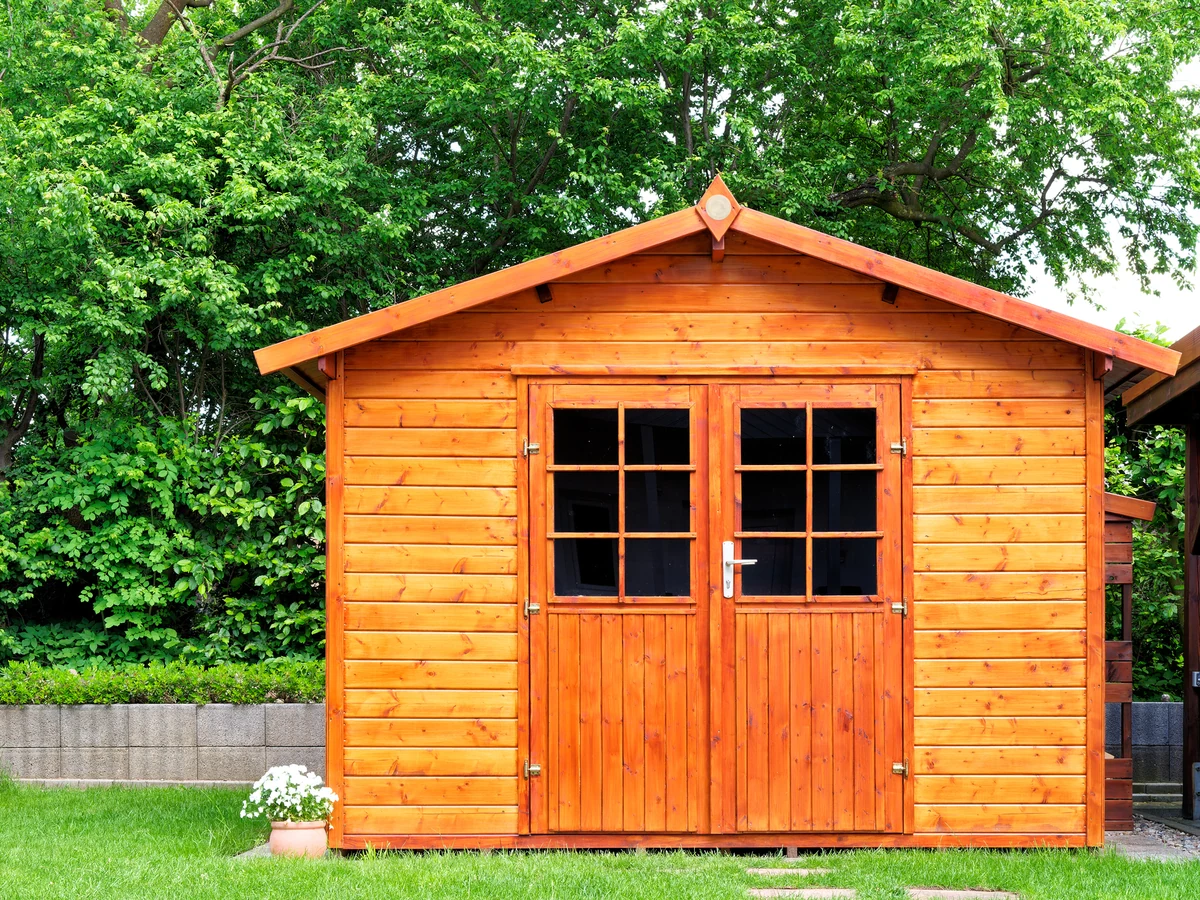 Natural wood garden shed freshly treated by Barnstaple Decorators